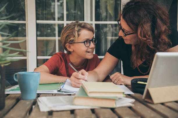 istock Woman Teaching Son Studying At Table 1188597289