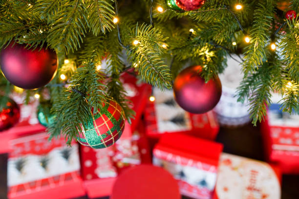 istock christmas tree background with colourful gifts, new year present 1188601333