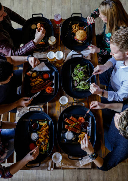 istock Friends sitting at the table in a pub and having dinner after work 1188601676