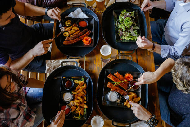 istock Sitting at the table in a pub and eating roast dinner with beer 1188601800