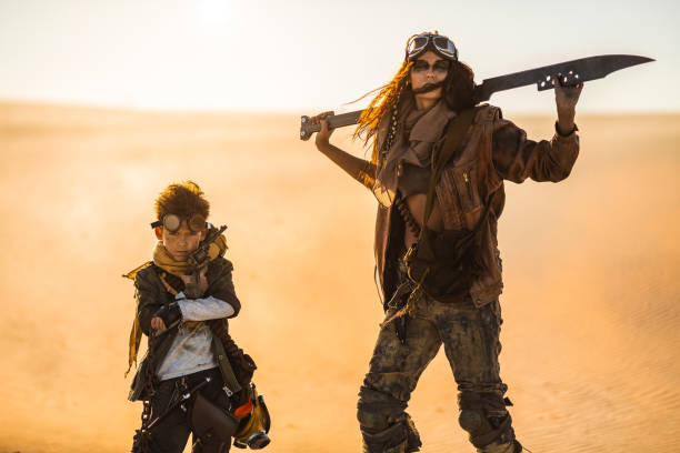 istock Post apocalyptic Woman and Boy Outdoors in a Wasteland 1188601890