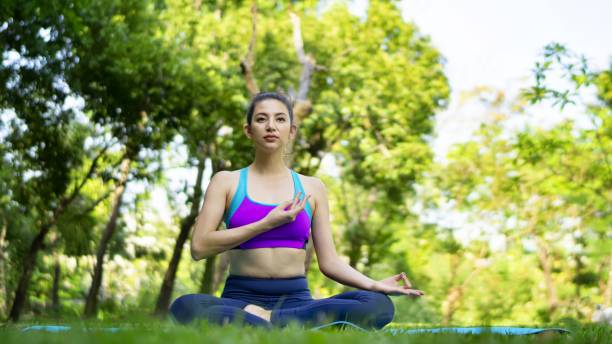 istock Woman Doing Yoga In Park 1188603367