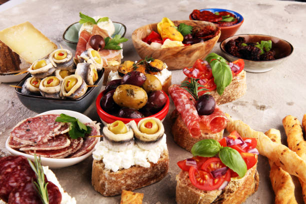 istock Appetizers table with italian antipasti snacks and wine in glasses. Brushetta or authentic traditional spanish tapas set, cheese variety 1188604173