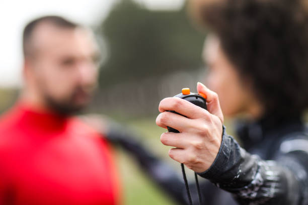 istock Female personal trainer showing her male client his performance and time recorded on a stopwatch 1188606193