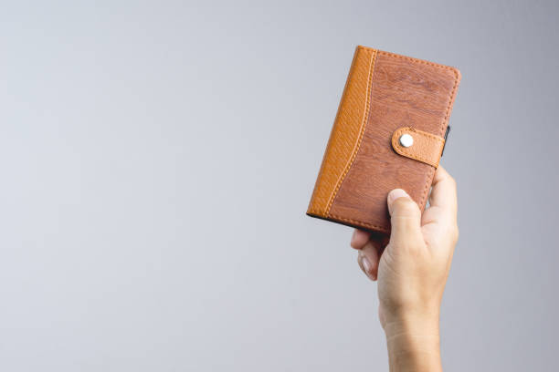 istock Hand holding vintage brown cover paper notebook 1188606222