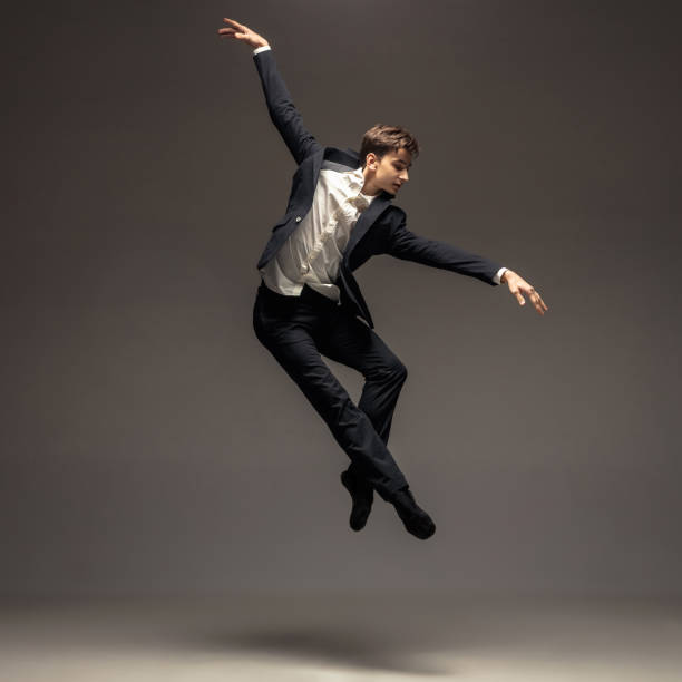 istock Man in casual office style clothes jumping isolated on studio background 1188606403