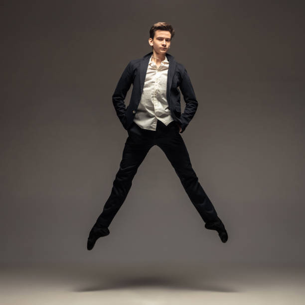 istock Man in casual office style clothes jumping isolated on studio background 1188606405