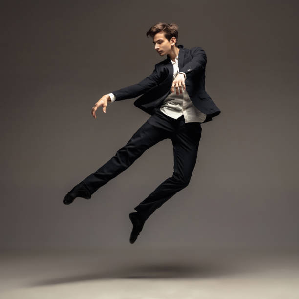 istock Man in casual office style clothes jumping isolated on studio background 1188606414