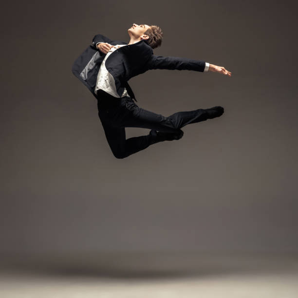istock Man in casual office style clothes jumping isolated on studio background 1188606415
