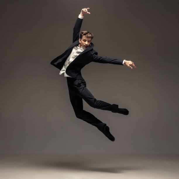 istock Man in casual office style clothes jumping isolated on studio background 1188606418