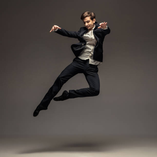 istock Man in casual office style clothes jumping isolated on studio background 1188606419