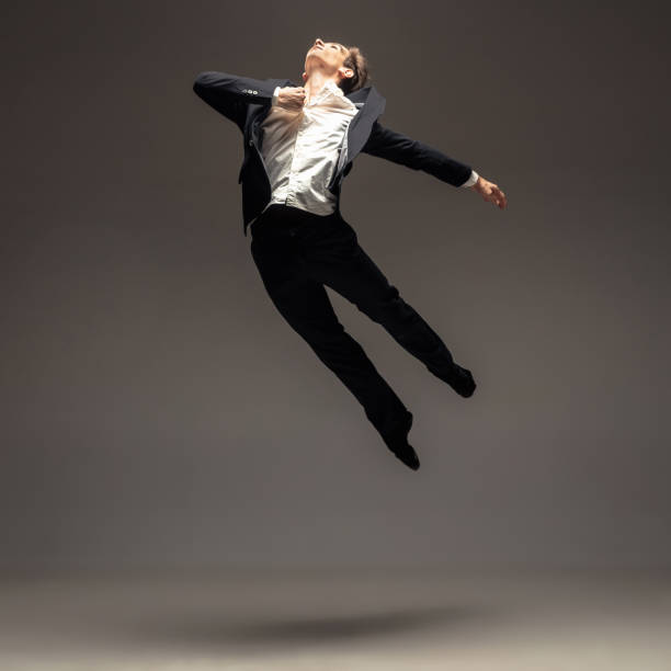 istock Man in casual office style clothes jumping isolated on studio background 1188606423