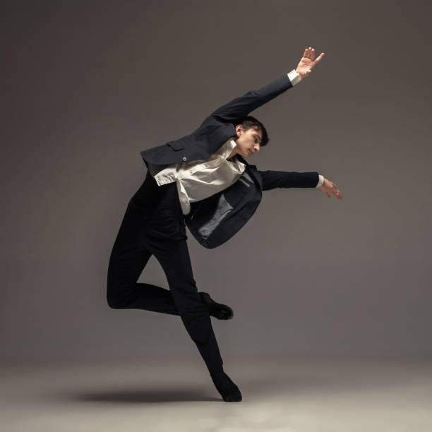 istock Man in casual office style clothes jumping isolated on studio background 1188606437