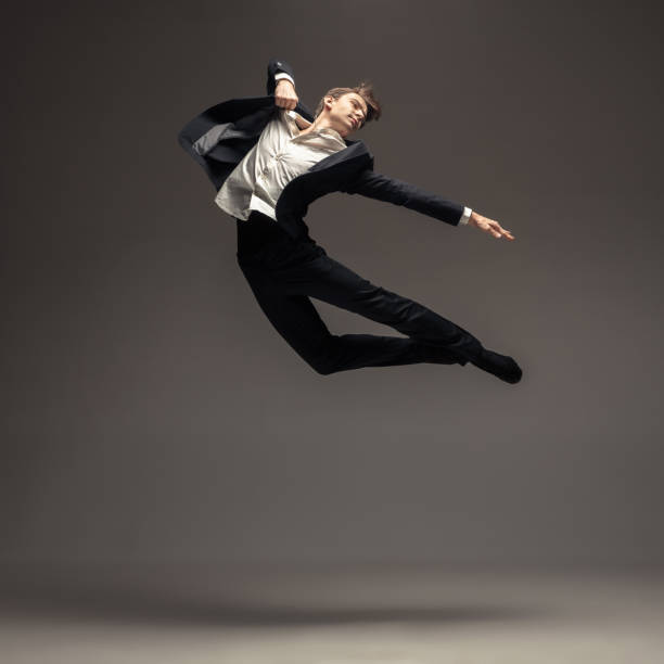 istock Man in casual office style clothes jumping isolated on studio background 1188606441
