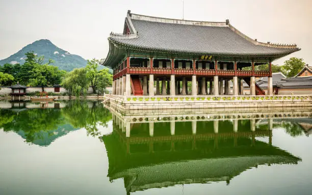 Gyeonghoeru Pavilion and pond view at Gyeongbokgung palace in Seoul and mount Inwangsan in background in Seoul South Korea