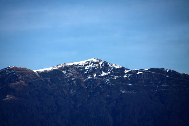 istock view over snow-covered mountain peak  against bue sky 1188608307