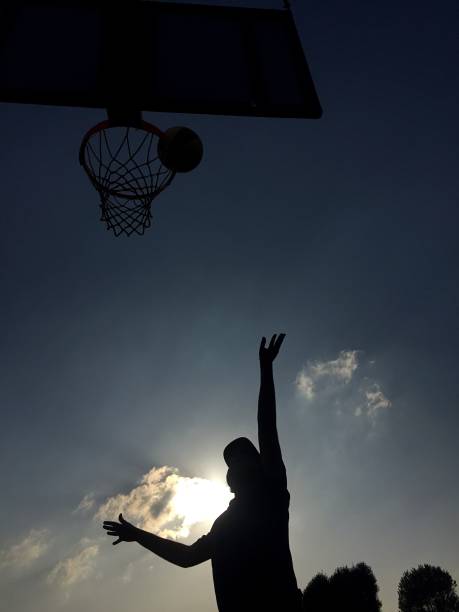 istock Playing basketball outdoors 1188609446