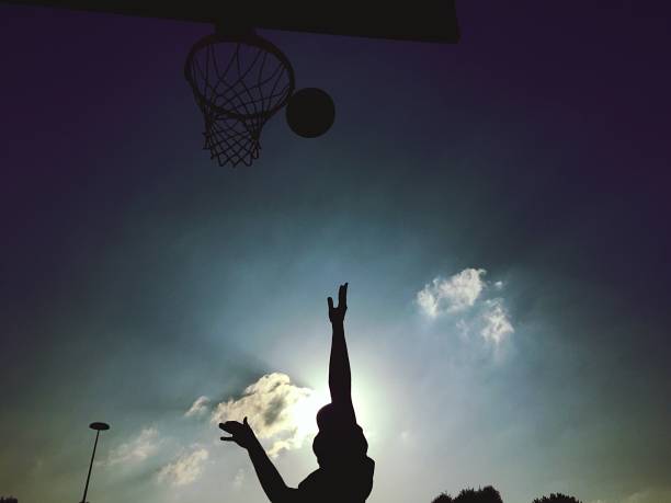 istock Playing basketball outdoors 1188609475