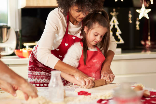 istock Girl making cookies with mom 1188609481