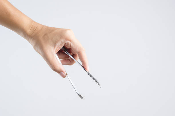 istock Hand holding steel ice tongs 1188609937