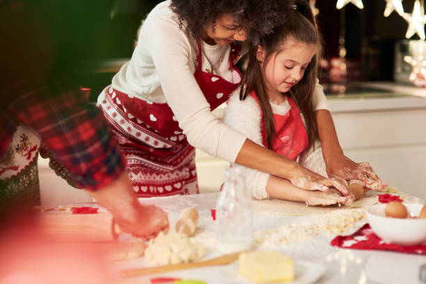 istock Girl making cookies with mom for Christmas 1188611055