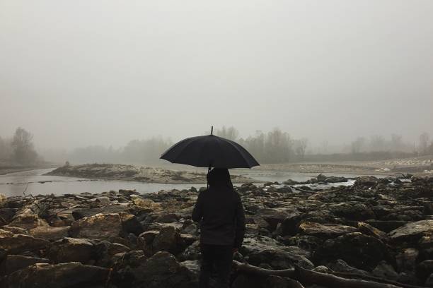 istock man in the fog with an umbrella 1188611565