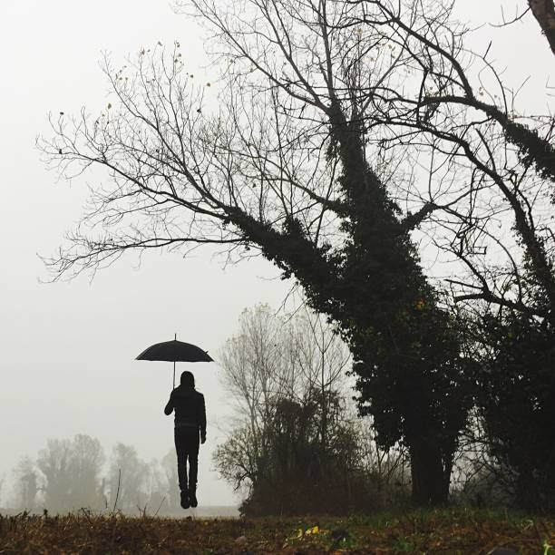 istock man in the fog with an umbrella 1188611657