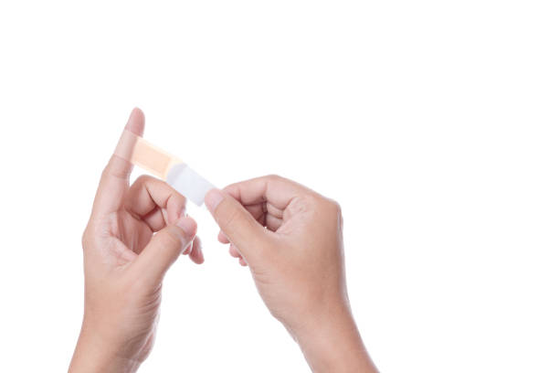 istock Hand holding adhesive first aid bandage, a medical plaster 1188611802