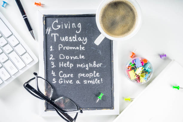 Giving Tuesday concept background Chalk board with list of tasks, ideas, task for Giving Tuesday. Notes to various helping on Tuesday. International Charity Aid Day concept. White desktop flatlay copy space giving tuesday stock pictures, royalty-free photos & images
