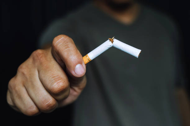 istock Man refusing cigarette holding in hand concept for quitting smoking and healthy lifestyle.or No smoking campaign Concept. dark black background. 1188612564