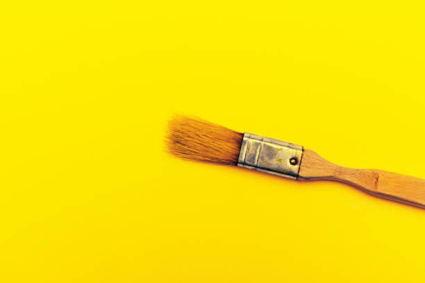 istock Paint brush on a bright yellow background. Art design 1188613811