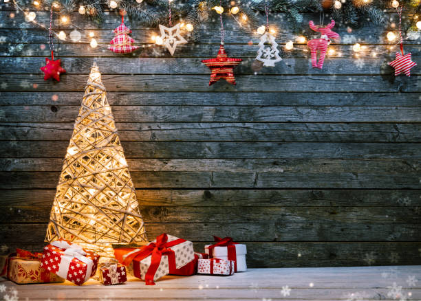 istock Holidays background with illuminated Christmas tree, gifts and decoration. 1188614481