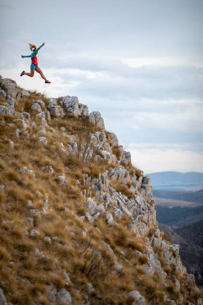 istock Young woman running on mountain 1188614495