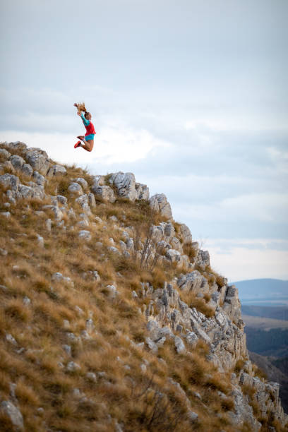 istock Young woman running on mountain 1188614589