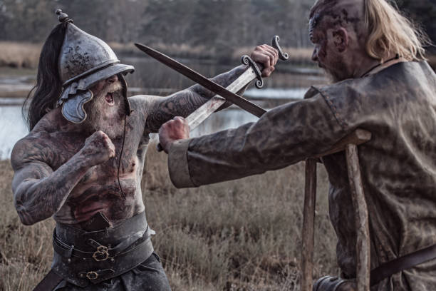 Two strong viking men fighting in hand to hand combat Two strong viking men fighting in hand to hand combat on a battlefield live action role playing photos stock pictures, royalty-free photos & images