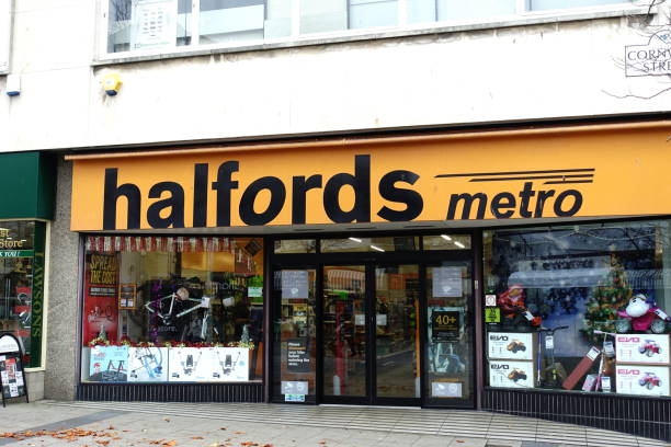 Halfords metro shop frontage. Double display windows with signage above entrance door. National chain of car accessory suppliers and cycle shop.