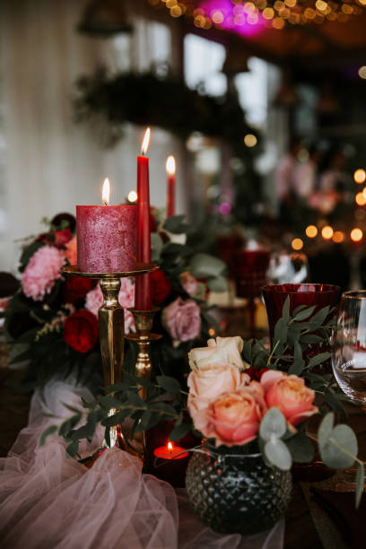 istock Beautiful, decorated table with flower decorations and red candles. Christmas evening or wedding party decoration. 1188617742