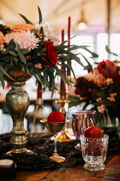 istock Beautiful, decorated table with flower decorations and red candles. Christmas evening or wedding party decoration. 1188617782