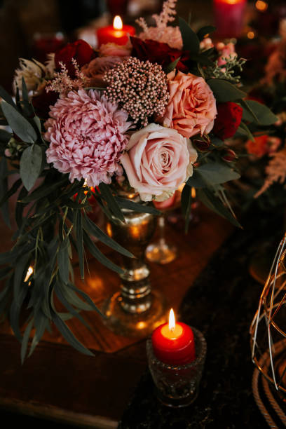 istock Beautiful, decorated table with flower decorations and red candles. Christmas evening or wedding party decoration. 1188617817
