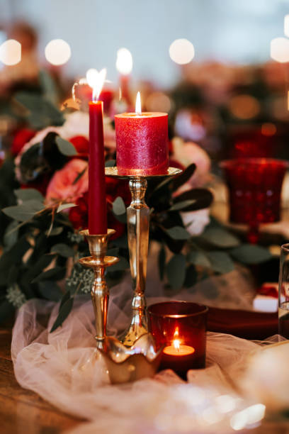 istock Beautiful, decorated table with flower decorations and red candles. Christmas evening or wedding party decoration. 1188617883