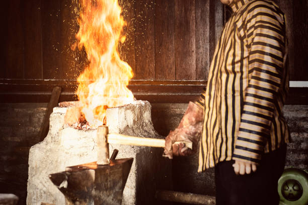 istock Blacksmith with a hammer wants to make keris 1188618279