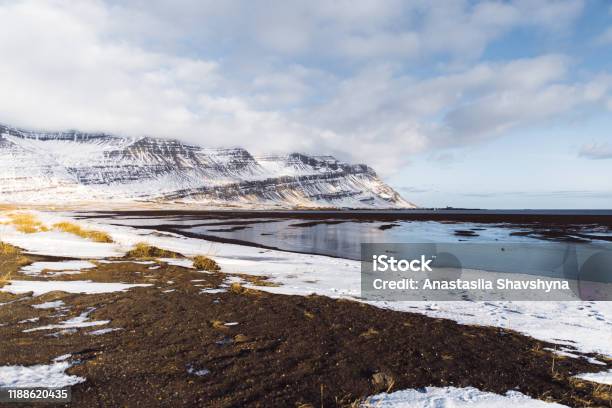 Winter Sunset Above Frozen Lake And Snowcapped Mountains In Iceland Stock Photo - Download Image Now