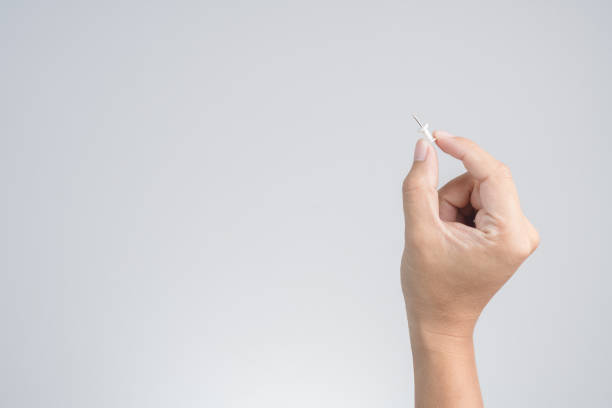 istock Hand holding push pin for paper or board 1188620612