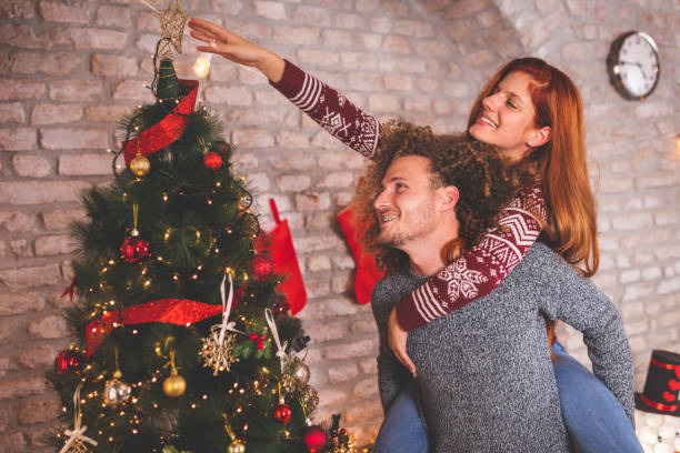 istock Couple placing a Christmas tree topper 1188622137