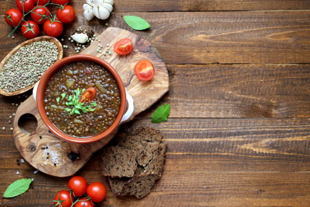 istock Delicious lentils soup on wooden background. 1188622270