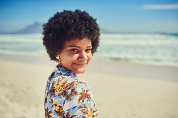 Shot of a beautiful young woman having alone time on the beach