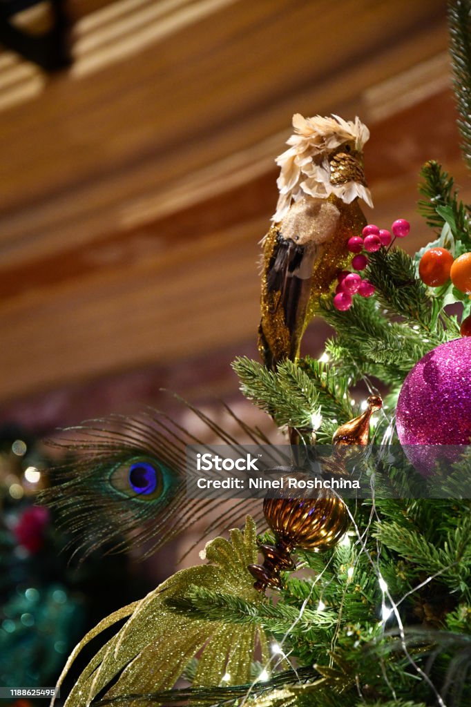 Sparkling Christmas Decorations With Yellow Dummy Parrot Peacock Feather  And Glittering Christmas Ornaments On Artificial Christmas Tree Decorated  By Shiny Lights Luxury New Year Decorations Stock Photo - Download Image  Now - iStock