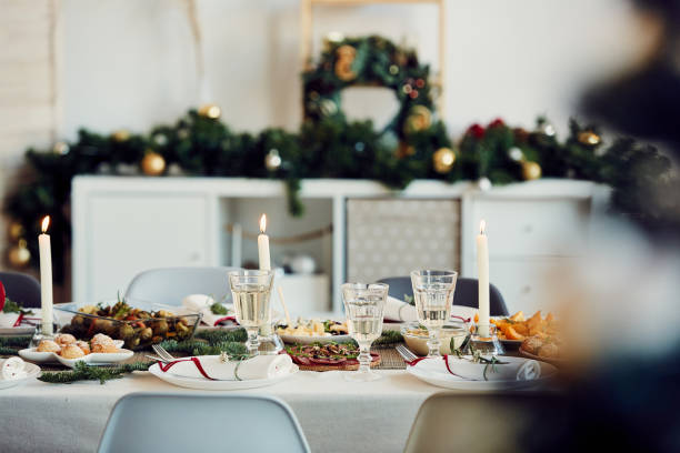 Served Dining Table on Christmas Background image of beautiful table setting for Christmas party with fir elegant candles and delicious homemade food, copy space restaurant place setting dinner dinner party stock pictures, royalty-free photos & images