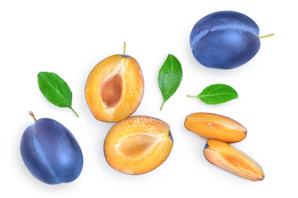 istock fresh blue plum and half with leaves isolated on white background. Top view. Flat lay 1188628257