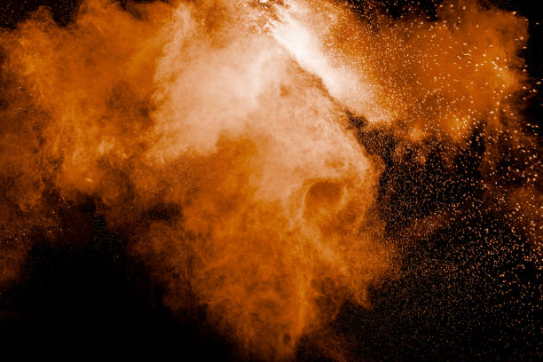 istock Orange color powder explosion on black background. 1188628330